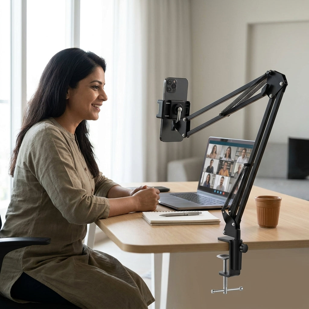 Black adjustable scissor-arm desk clamp phone and tablet holder stand with spring-assisted joints and device cradle